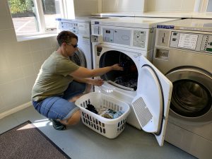 Karen loading a tumble dryer